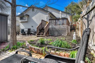 Private backyard with tiered landscaping and cozy seating, perfect for relaxing afternoons or evening chats