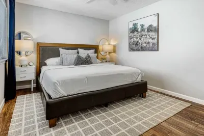Cozy bedroom with king bed, layered linens, and warm lighting designed for restful nights