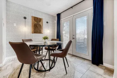 Intimate dining space with statement lighting and a designer accent wall for elevated meals at home