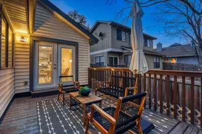Seamless indoor-outdoor flow with warm lighting and relaxed deck seating