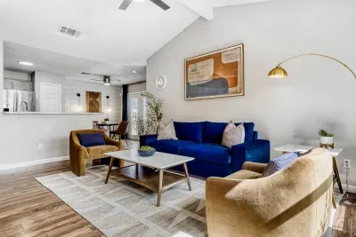 Bright, vaulted living room with plush seating and natural light; perfect for slow mornings or evening resets