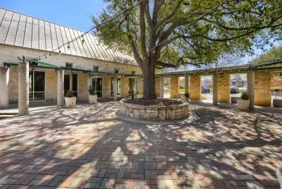 Community courtyard with shaded seating and string lights for gatherings