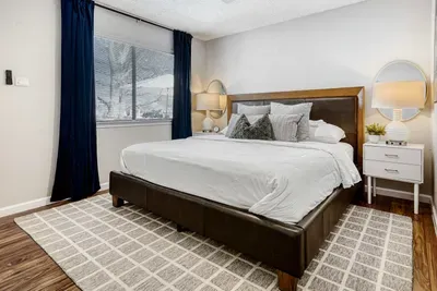 Clean and calming space with soft textures and blackout curtains for uninterrupted sleep