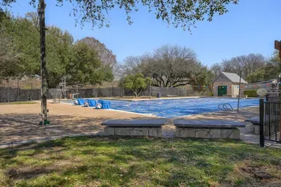 Resort-style community pool with lap lanes and shaded seating