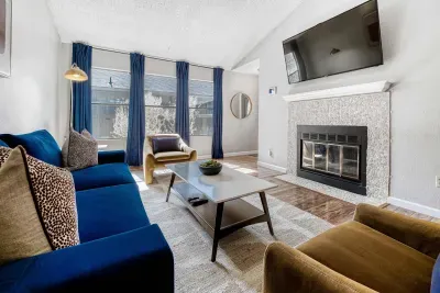 Sunlit lounge with curated seating and smart TV making it deal for movie nights or casual hangs