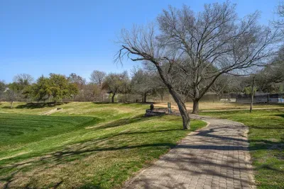 Scenic walking trails winding through green space and mature trees