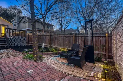 Private yard with string lights and fire feature for cozy nights outdoors