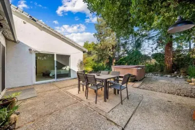 Spacious outdoor patio with dining table, perfect for meals and relaxing outdoors.