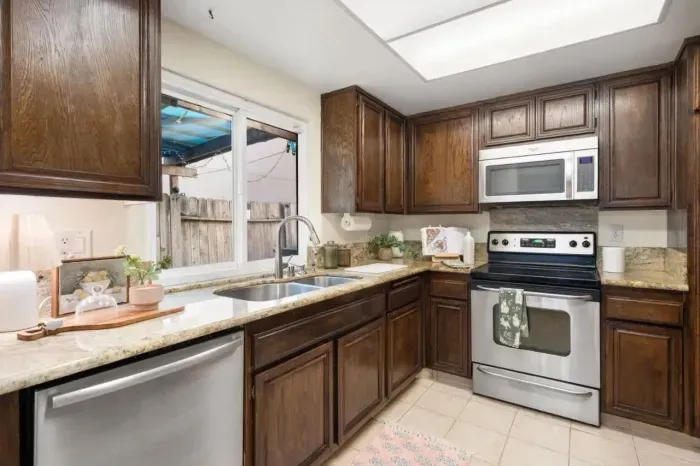 Well-organized kitchen featuring stainless steel appliances and generous prep space.