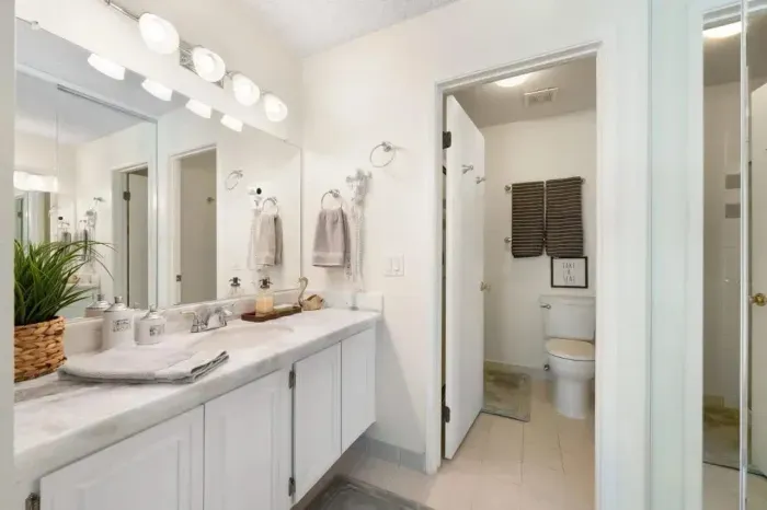 Clean, well-lit bathroom with double vanity and modern finishes.