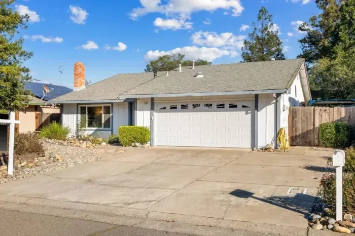 Ample parking with a wide driveway and attached garage for added convenience.