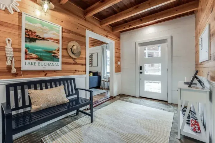 Enter through a breezeway-style foyer, designed to bring in natural light and a fresh breeze. This open, airy space connects the indoors to the outdoors, creating a seamless and inviting entry to the home.