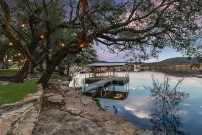 Serene backyard spot under the trees with twinkle lights.
