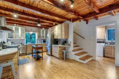 Fully equipped kitchen with farmhouse accents and island seating.