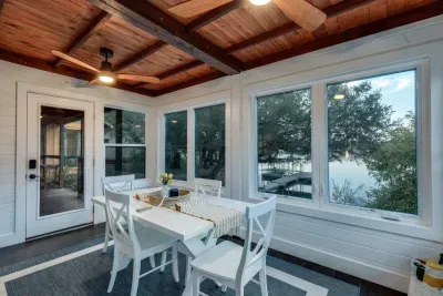 Sunroom dining area with wide windows and natural light.