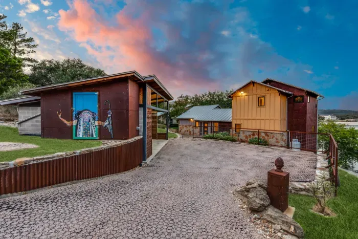 Welcoming exterior with private driveway and cabin-style design.