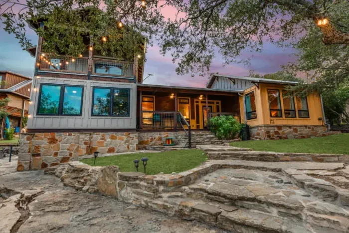 Exterior view of the home glowing at dusk with a welcoming atmosphere.