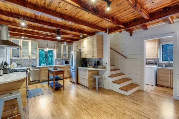 Spacious kitchen with wood ceilings and rustic charm.