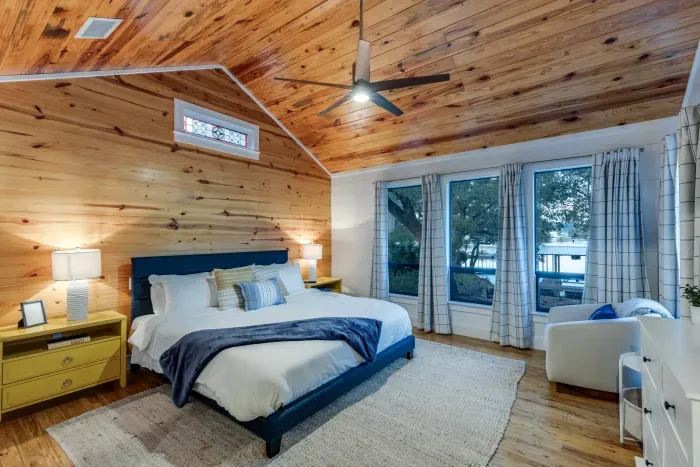Comfortable bedroom with warm wood details and soft lighting.