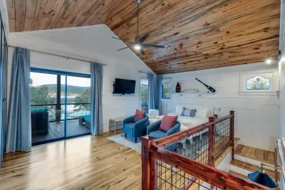 Upstairs loft bedroom with cozy lighting and lake breeze.