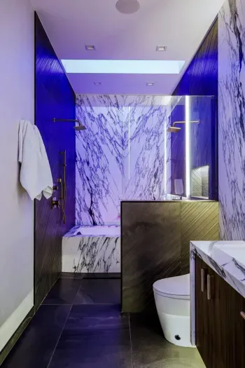 Fresh and stylish bathroom with a large vanity and sleek lighting..