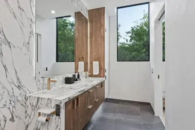 Modern bathroom with sleek fixtures, a spacious shower, and high-end amenities.