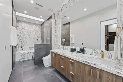 Spa-like bathroom with marble countertops, soft lighting, and plush towels.