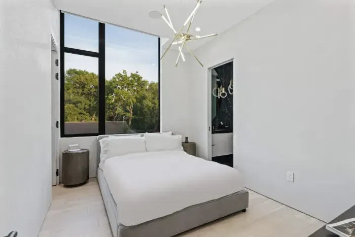 A stylish queen-size bed, smart lighting, and a cozy ambiance make this room the perfect spot to relax after a day of exploring.