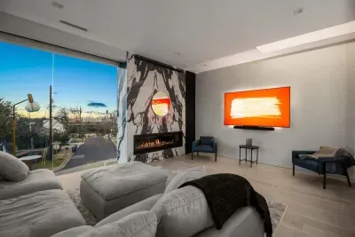 Kick back on oversized sofas, cozy up by the fireplace, and enjoy movie nights on the big screen with sunset views just outside