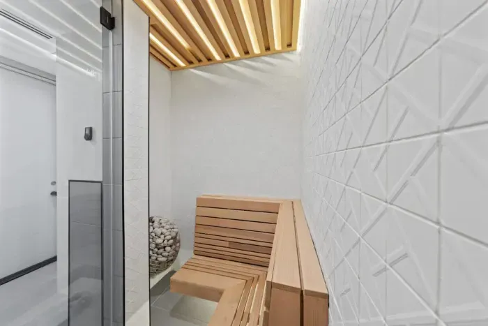 A modern sauna and bathroom seamlessly integrate to create a luxurious retreat, where sleek design and natural materials transform everyday routines into a spa-like experience.