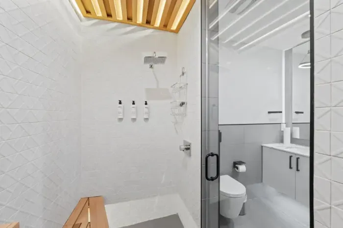 Modern bathroom with sleek fixtures, a spacious shower, and high-end amenities.