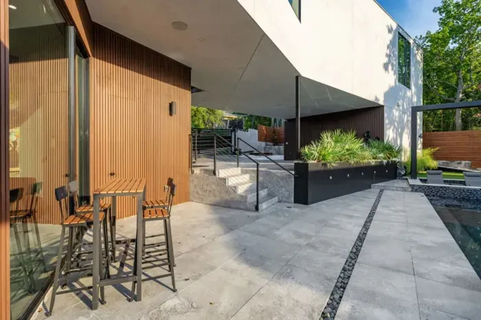 Backyard with a spacious deck and a dining area, ideal for hosting family dinners or casual get-togethers.