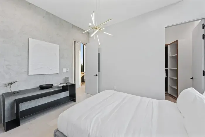 Modern bedroom with minimalist design and high-quality bedding.