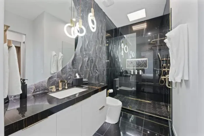 Fresh and stylish bathroom with a large vanity and sleek lighting..