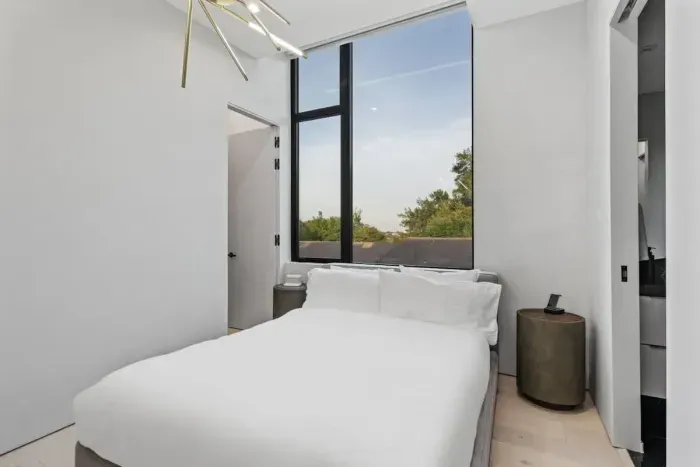 Natural light floods this charming room, complete with a queen-size bed and stylish furniture, making it the perfect spot for a peaceful stay.