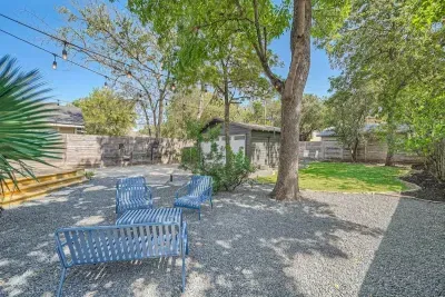 Cozy backyard retreat with string lights, a fire pit, and comfortable seating.