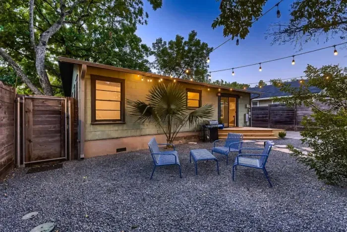 Vibrant backyard with a colorful mix of plants and flowers, creating a bright and cheerful atmosphere.