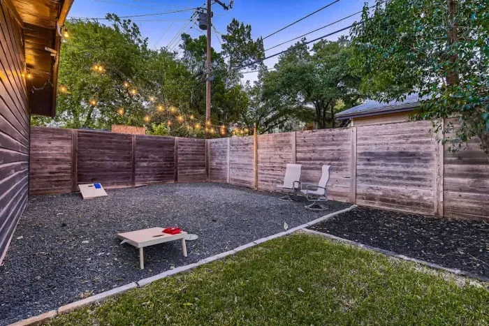 Well-maintained backyard with a variety of trees and shrubs for a natural, private setting.