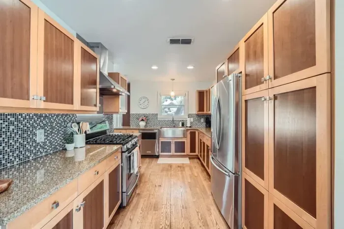 Warm and inviting kitchen with beautiful countertops and all the comforts of home.