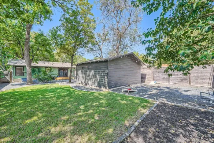 Family-friendly backyard with a play area, plenty of green space, and outdoor seating.
