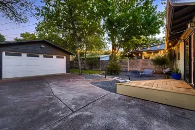 Well-maintained backyard with a variety of trees and shrubs for a natural, private setting.