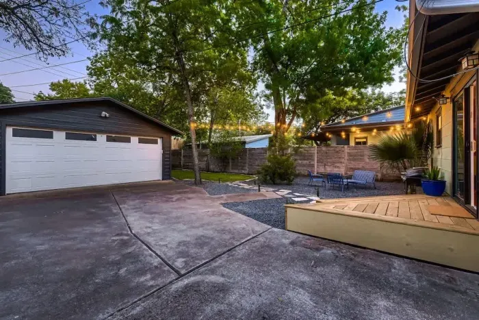 Well-maintained backyard with a variety of trees and shrubs for a natural, private setting.