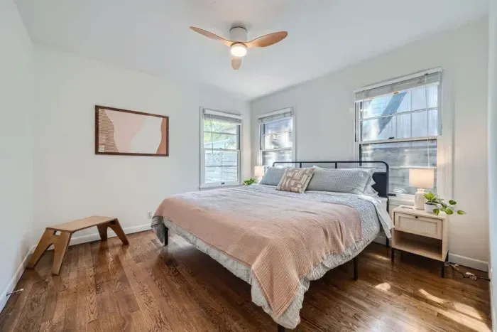 Romantic bedroom with elegant lighting and soft, neutral tones.