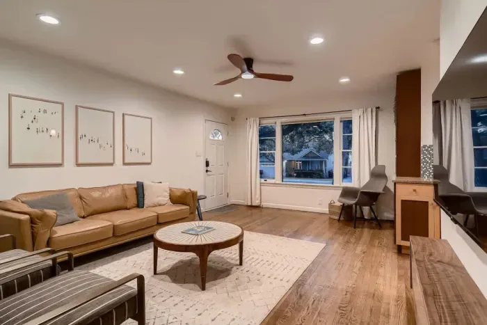 Rustic-inspired living area with wooden beams and cozy textiles for a cabin-like feel.