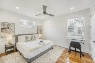 Comfortable guest bedroom with hardwood floors.