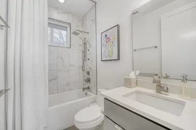 Full guest bathroom with tub and shower.