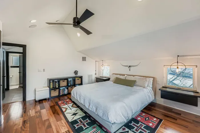 Spacious primary bedroom with ceiling fan.