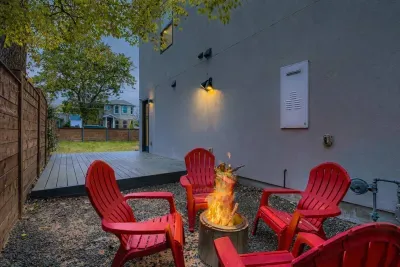 Backyard fire pit with lounge chairs.