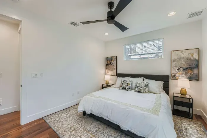 Guest bedroom with cozy bedding and ceiling fan.