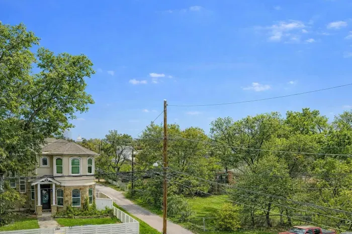 Neighborhood view with tree lined street.
